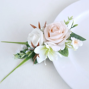 Elegant champagne and white silk rose boutonniere with lily and pearl accents for weddings