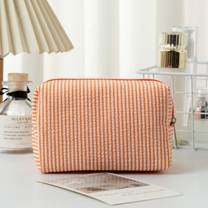 Orange and white seersucker striped cosmetic bag with silver zipper and large capacity