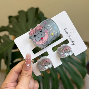 Detail of cute hippo hair clip set with stars and sequins on translucent acrylic base