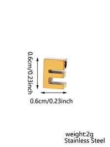 Macro shot of 0.6cm gold stainless steel letter E pendant charm with zircon inlay