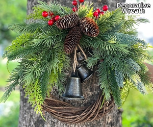 Rustic Christmas wreath with pine needles, red berries and vintage metal bells on wood