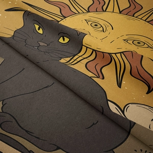 Close-up of bohemian tarot tapestry fabric showing detailed cat and sun pattern texture