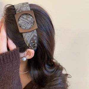 Detail view of vintage paisley fabric headband with a stylish wooden square buckle