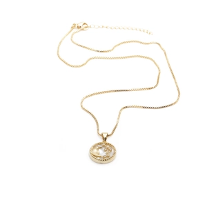 Minimalist gold necklace with zircon moon and star pendant on a white background