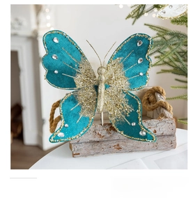 Detailed close-up of peacock blue velvet butterfly ornament with gold glitter and crystals