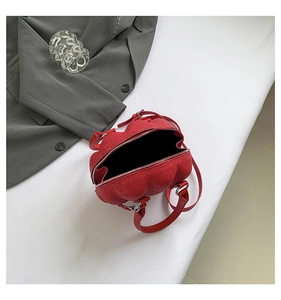 Top view of red floral embossed shell bag showing zipper opening and spacious interior