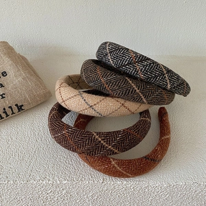 Detailed set of five knitted plaid headbands in various autumn colors and wool textures
