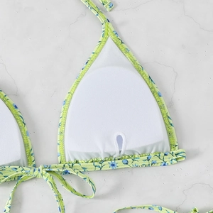 Detailed macro view of green floral bikini top with built-in chest pad slot inserts