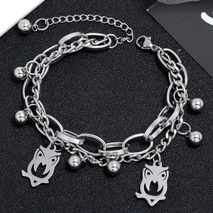 Detail of silver double-layered chain bracelet with owl pendants and lobster clasp