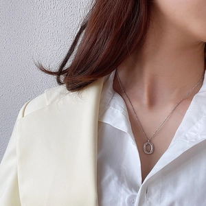 Chic 925 sterling silver oval donut necklace worn on neck with professional office wear