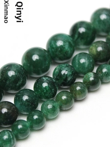Macro shot of natural green fuchsite beads in various sizes for DIY jewelry making