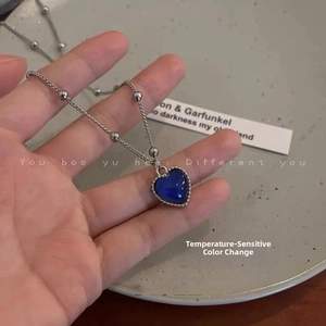 Detailed close-up of a color-changing heart pendant necklace with temperature sensing