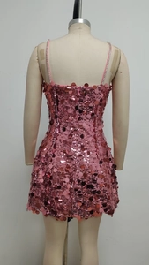 Detail of pink sequin mini dress back view with thin straps and sleek zipper closure