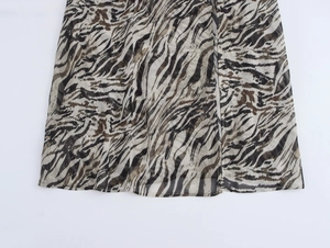 Detailed close-up of tiger print chiffon dress showing the side slit and fabric texture