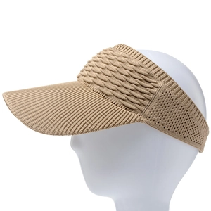 Detail of beige knitted sun visor with elastic wavy texture and breathable open top
