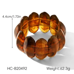 Detail view of amber resin stretch bracelet with tortoiseshell pattern and 4.4cm width