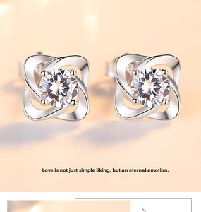 Macro shot of S999 sterling silver clover stud earrings with sparkling cubic zirconia