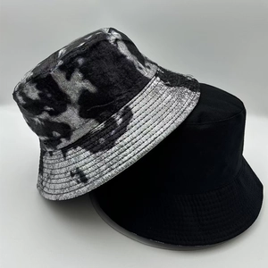 Top view of two stylish fisherman bucket hats in black and silver tie-dye laser texture