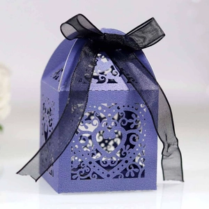 Macro shot of purple hollow heart gift box with elegant black organza ribbon detail