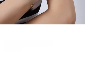 Detail of 18K gold plated Cuban chain bracelet featuring a polished metallic texture finish
