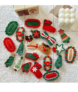 Flat lay of handmade crochet Christmas hair clips with festive tree and reindeer motifs