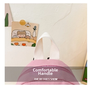 Detail of pink canvas backpack showing reinforced soft handle and sturdy stitching