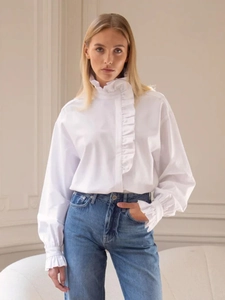 Elegant white long-sleeve blouse featuring stand collar and ruffle details with jeans