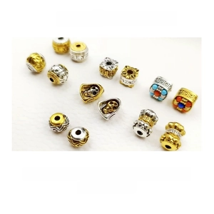 Macro detail of Tibetan silver barrel beads with gold-silver plating and vintage engravings