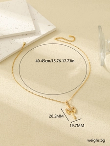 Detail view of gold stainless steel winged heart key pendant with zircon measurements