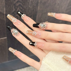 Luxurious black and nude pink long coffin press-on nails with shiny rhinestones