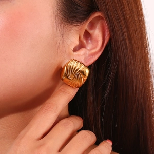 Detail of 18K gold-plated square stud earrings with spiral water ripple texture on model
