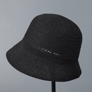 Detail view of black knit sun hat featuring breathable diamond hollow crochet pattern