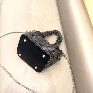 Close-up of rhinestone evening bag base with protective metal studs and silver chain