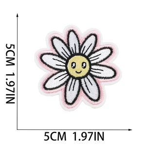 Detail showing colorful daisy embroidery patch with smile face and 5cm size scale