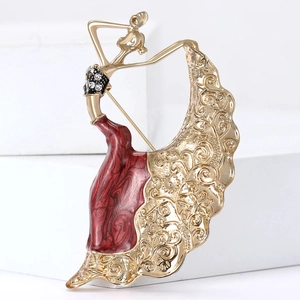 Elegant gold peacock dancer brooch with red enamel skirt and sparkling crystal details