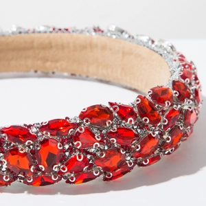 Macro view of luxurious red rhinestones and velvet lining on a baroque headband