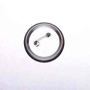 Macro shot showing the secure silver metal safety pin on the back of a round badge