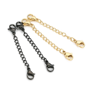Detailed view of gold and gunmetal stainless steel extension chains with lobster clasps