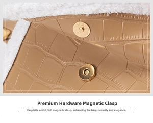 Detail of golden magnetic clasp on brown crocodile texture bag with wool trim