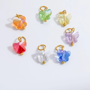 Macro shot of colorful crystal butterfly charms with gold rings for DIY bracelets