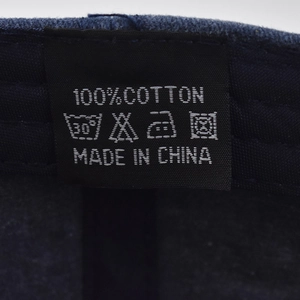 Detailed view of 100% cotton washing label and inner stitching on vintage baseball cap