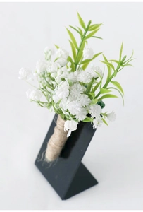 Detailed view of artificial baby's breath boutonniere with rustic twine wrapped handle