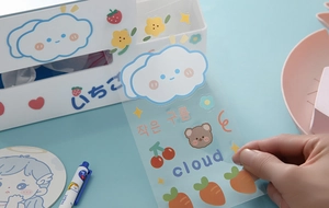 Close-up of peeling a cute waterproof cartoon PVC sticker from a sheet for decoration