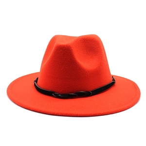 Detail of orange wide-brim wool fedora hat featuring a black woven band and felt texture