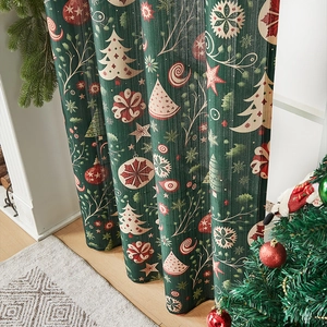 Detail of dark green Christmas curtain showing thick texture and festive tree prints