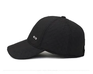 Detail view of black quilted baseball cap with metal SPORT badge for winter warmth