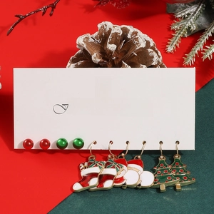 Close-up of five pairs of festive Christmas earrings including Santa and Xmas tree