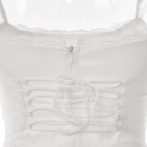 Detail of white satin dress back featuring lace trim, zipper and lace-up corset design