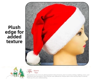 Detail of red velvet Christmas hat showing plush white fur trim and pom-pom texture
