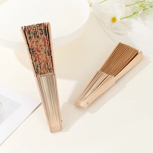 Detailed view of vintage cork folding fans with patterned fabric and wooden ribs